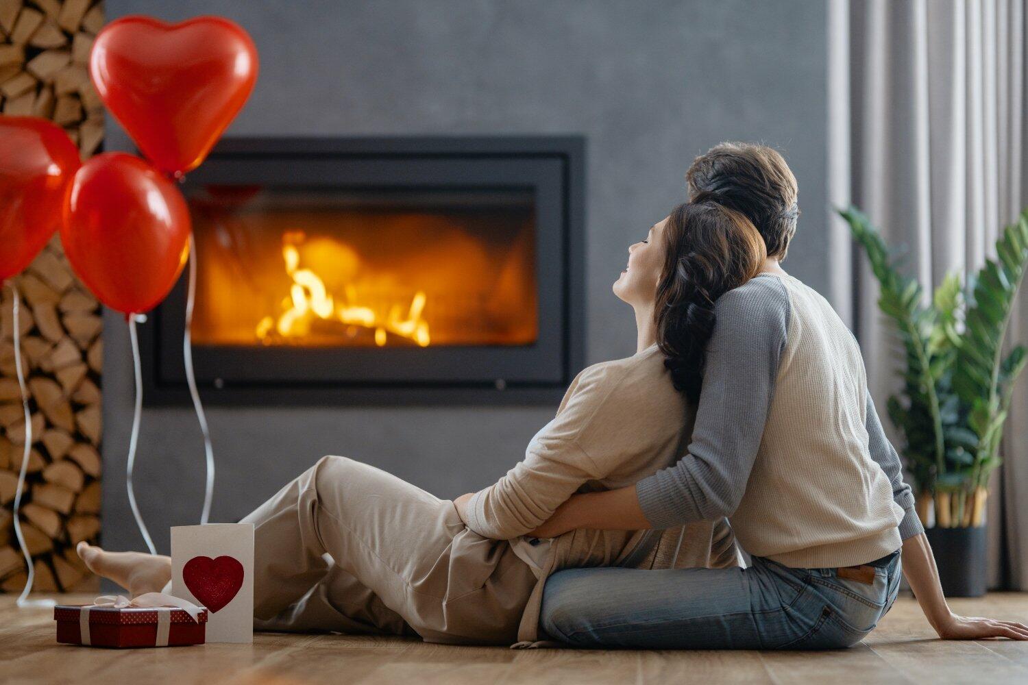 Happy loving couple on valentine's day. Man and woman are enjoying spending time at home.