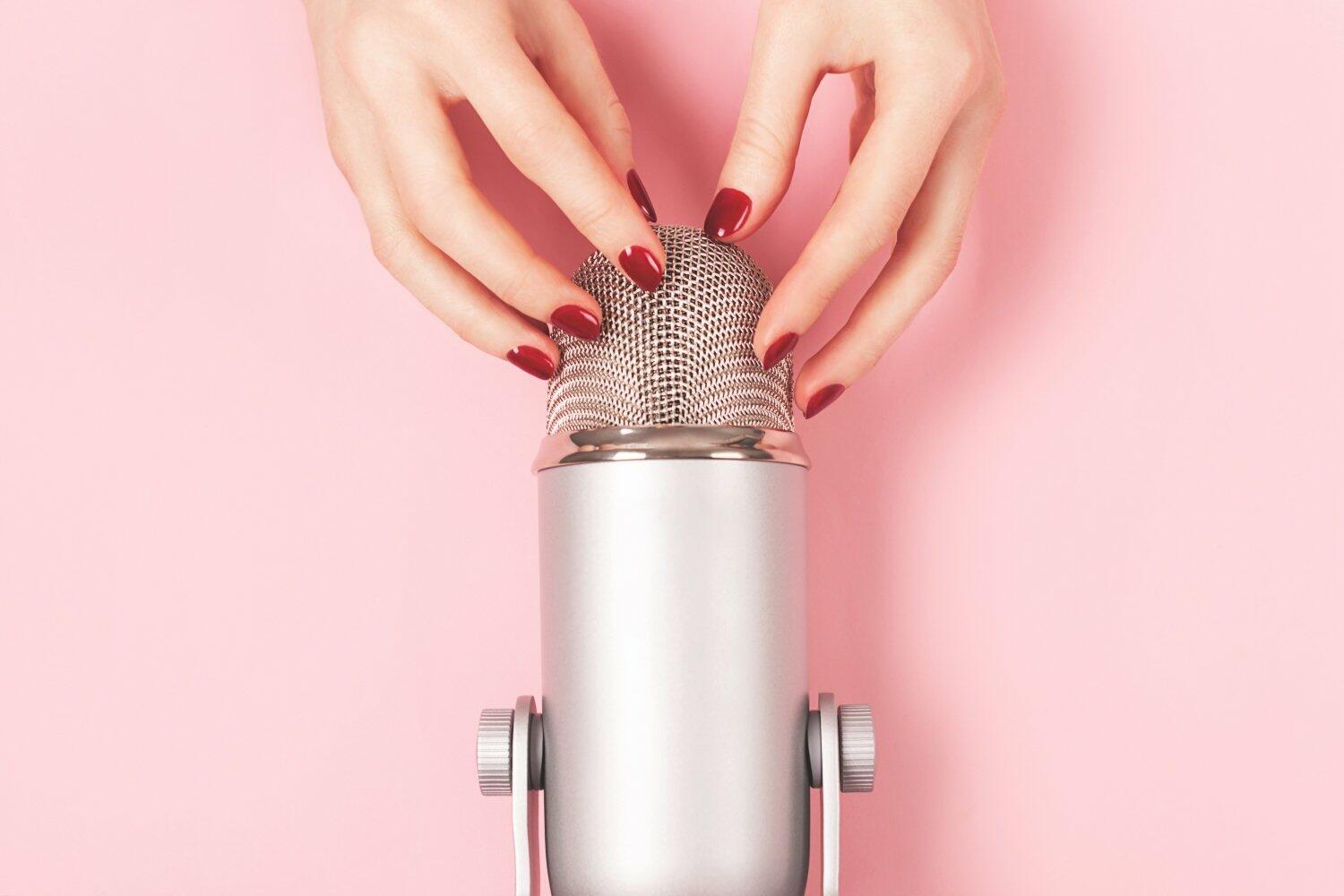 Woman hand with perfect manicure near the microphone is about to do nail tapping. Making ASMR sounds. Triggers for relaxation, good sleep and stress relief.