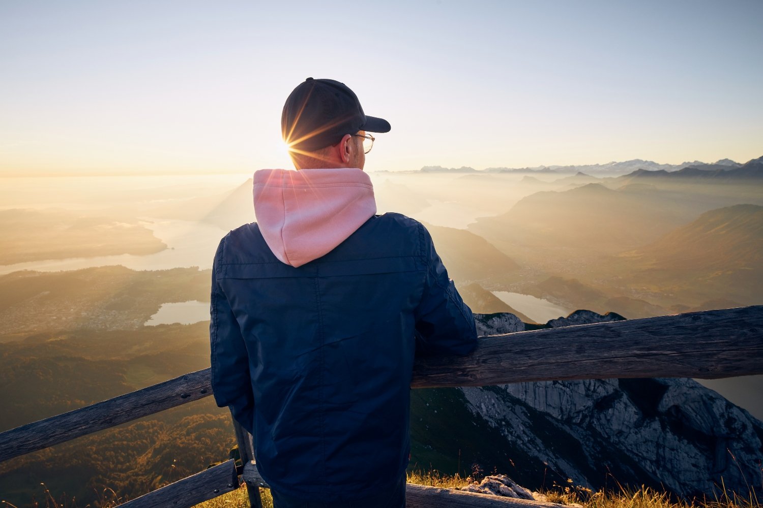 Hiker looking at mountain range at sunrise
