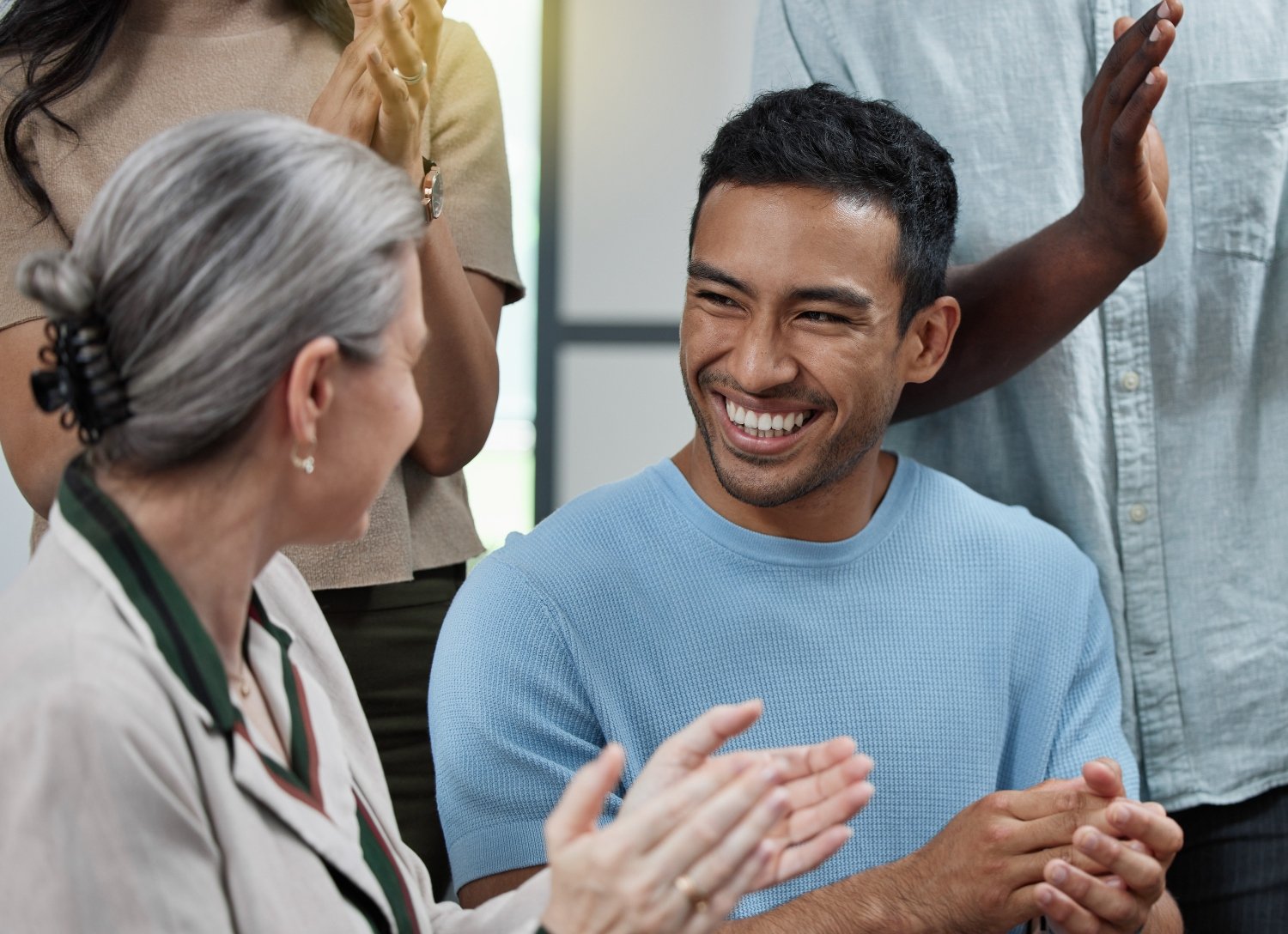 Shot of a group of businesspeople applauding in an office