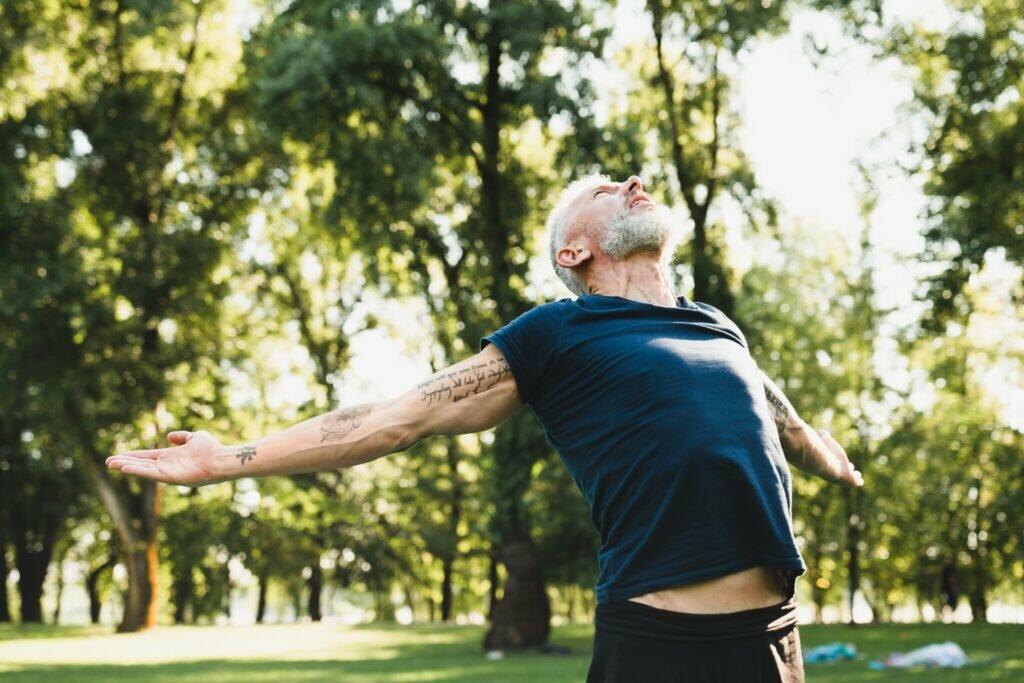 Closeup cropped shot of freedom and pleasure. Healthy mature man doing breathing exercises