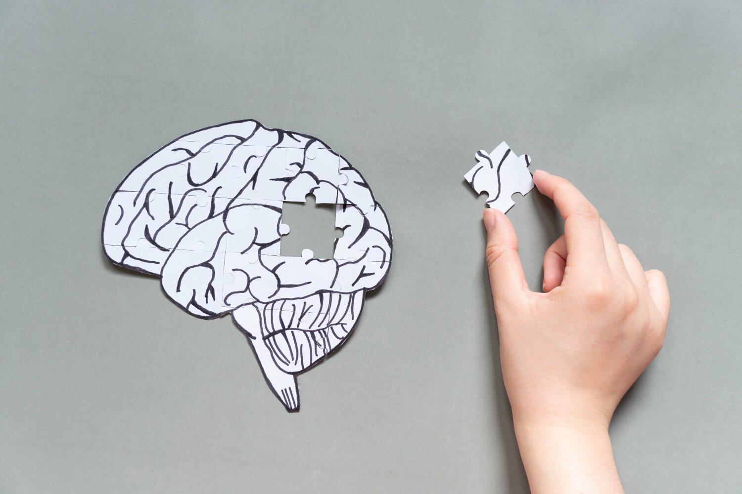 cartoon image of a brain with removed puzzle part