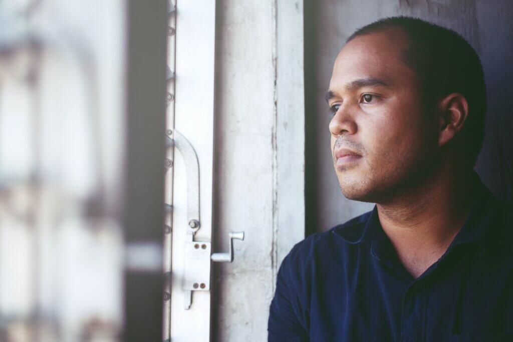 depressed man Absent-minded stand edge the window