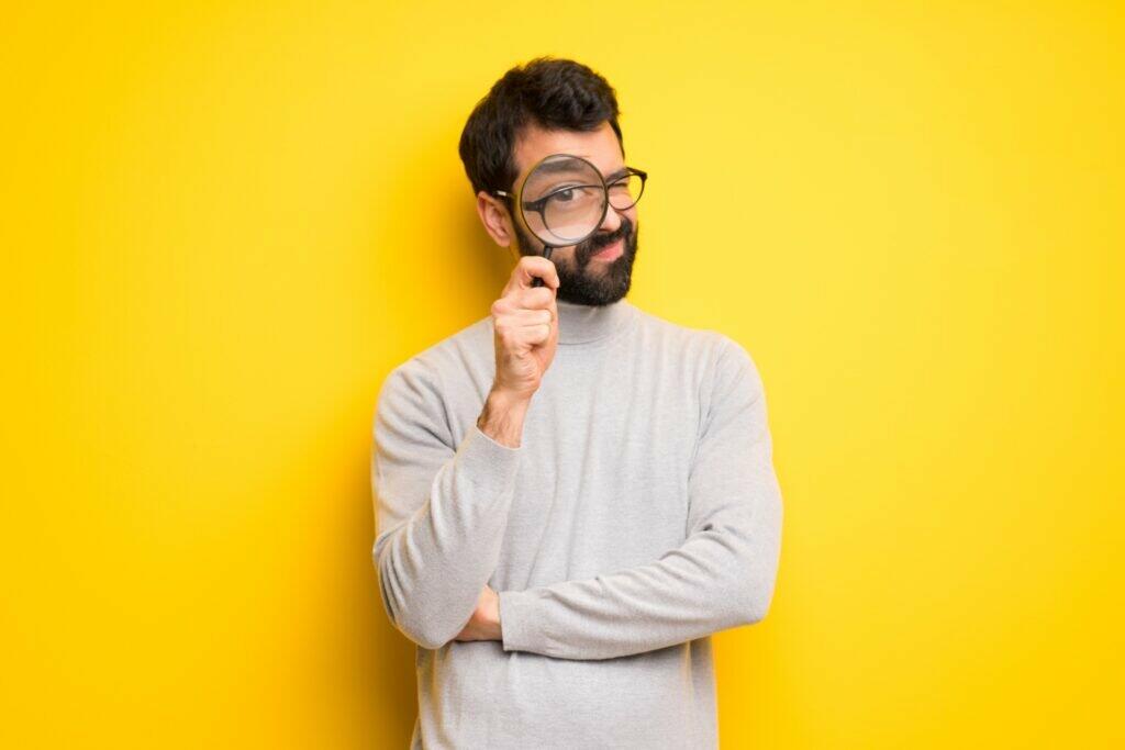 perfectionist man holding a magnifying lens