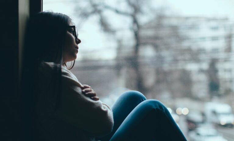 sad-woman-sitting-by-the-window